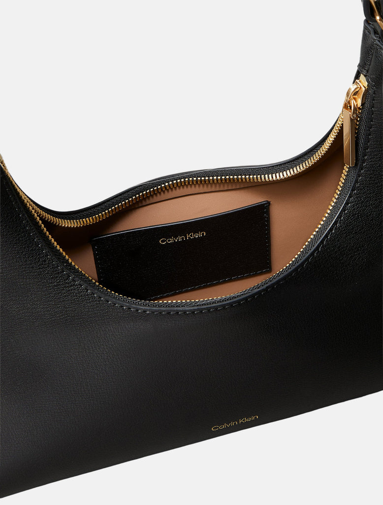 Calvin Klein crna ženska torba sa zlatnim detaljima-[SKU]