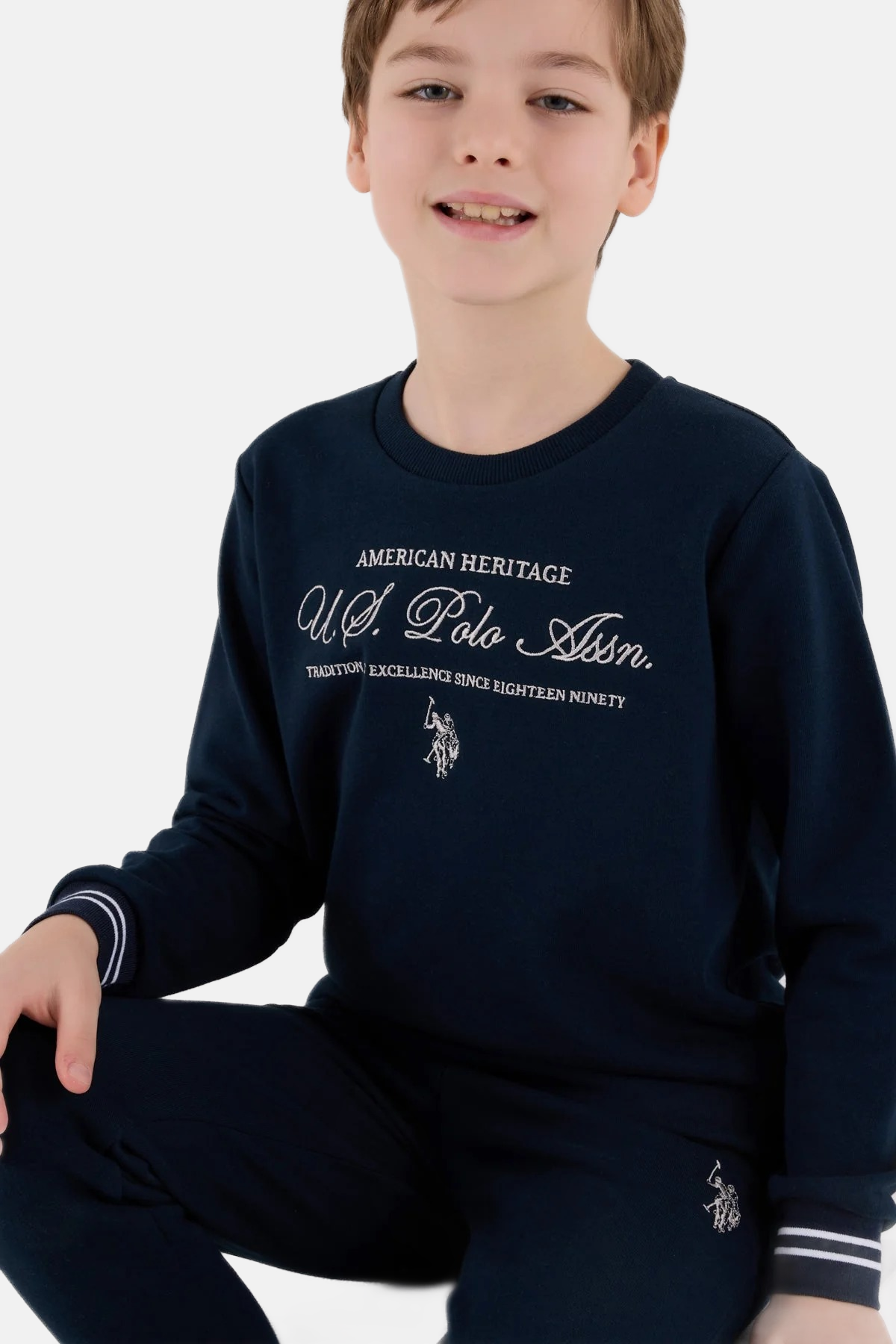 U.S. Polo Assn. teget plava trenerka za dječake s natpisom na grudima i prugastim manžetnama