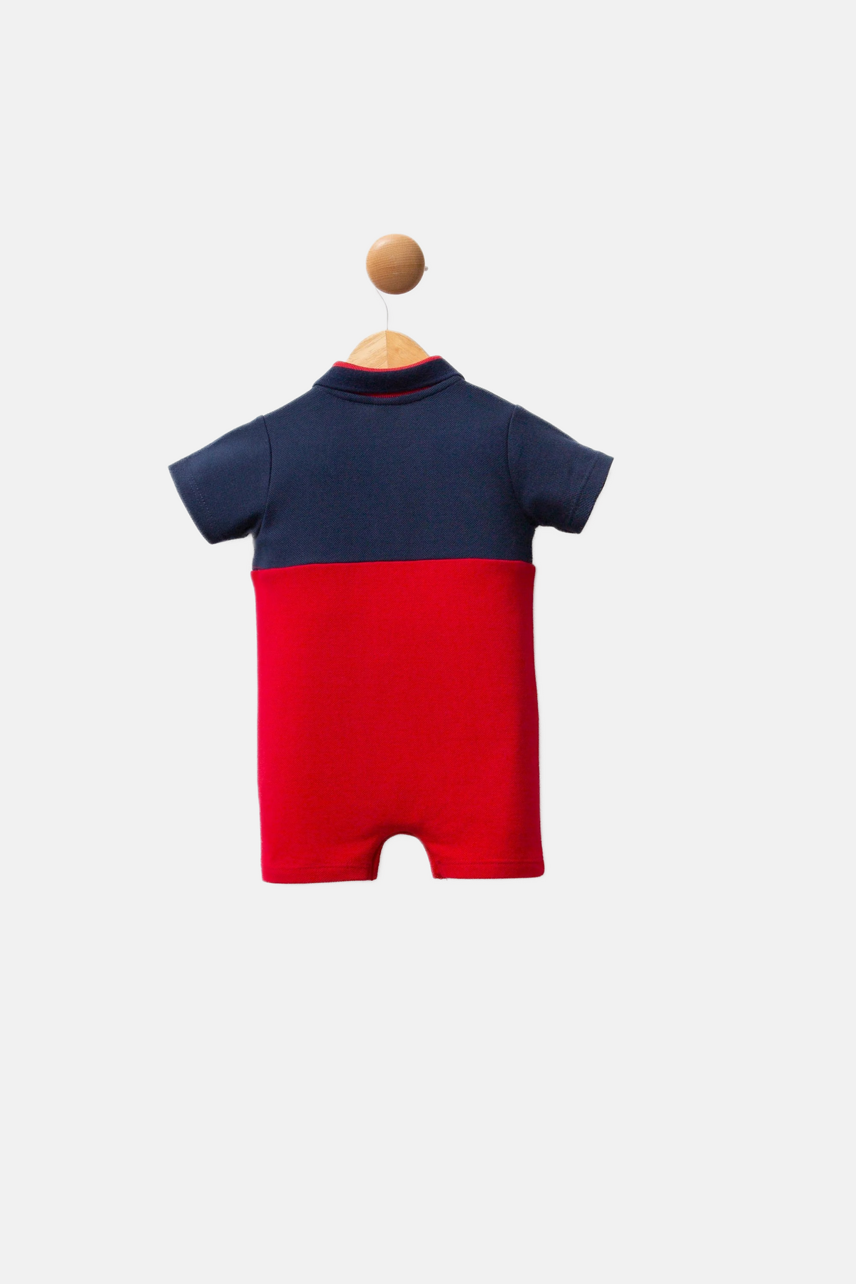 U.S. Polo Assn. teget plavi kombinezon za bebe s crvenim detaljima