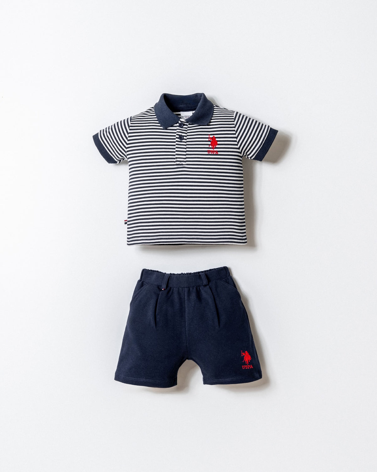 U.S. Polo Assn. bijelo-teget komplet prugaste polo majice i teget šorca za bebe