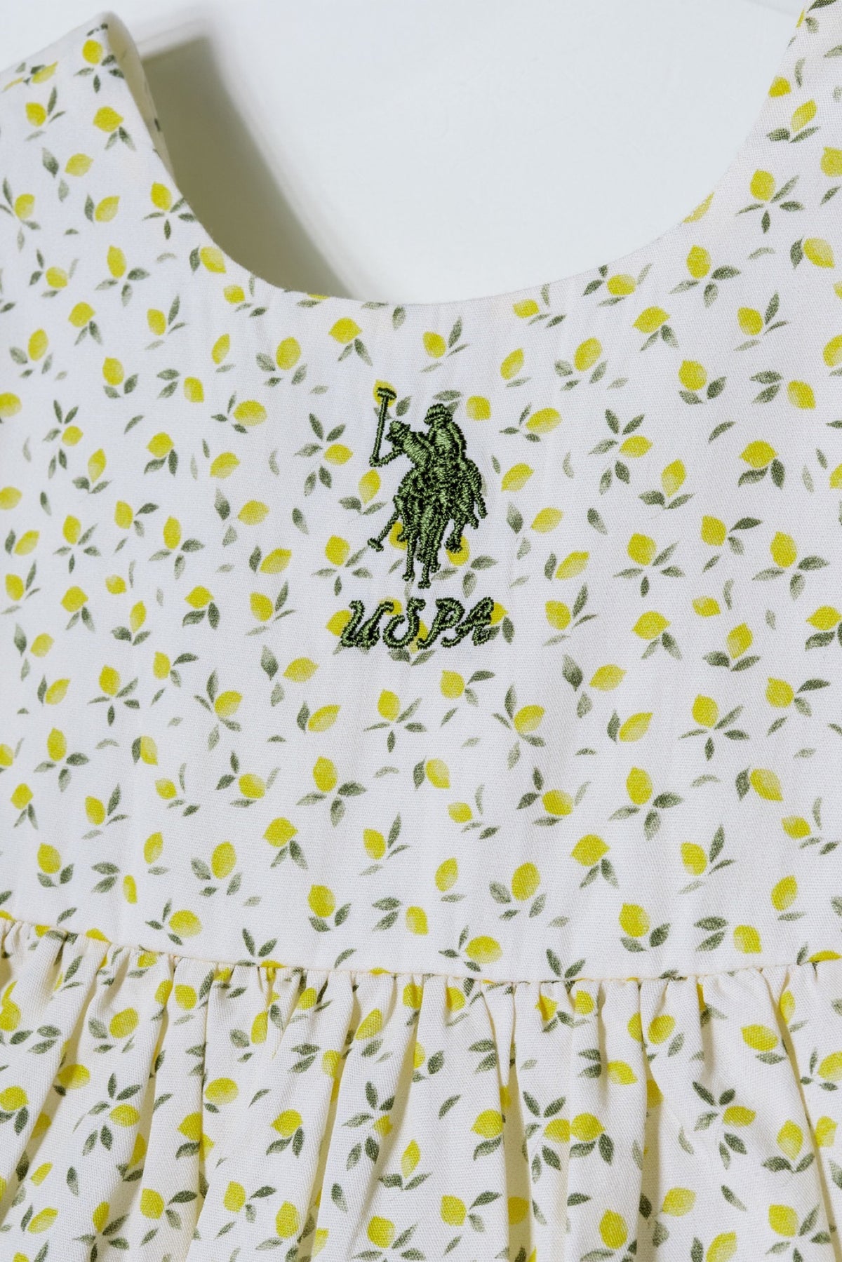U.S. Polo Assn. ekru haljina za bebe s printom limuna