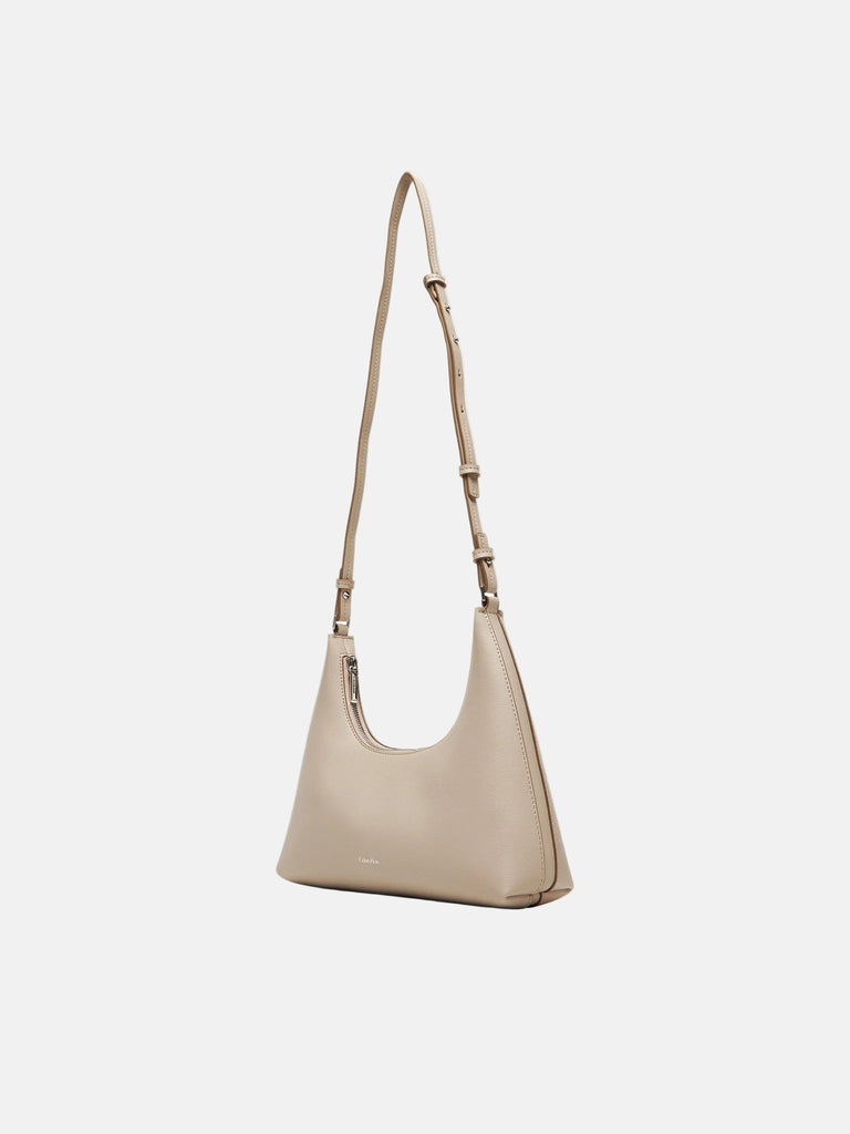 Calvin Klein bež ženska torba sa diskretnim logom-[SKU]